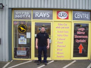 man standing outside rays