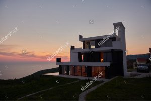 house on cliff at sunset