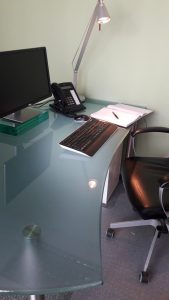 glass desk and computer