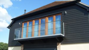 glass balcony off painted timber house