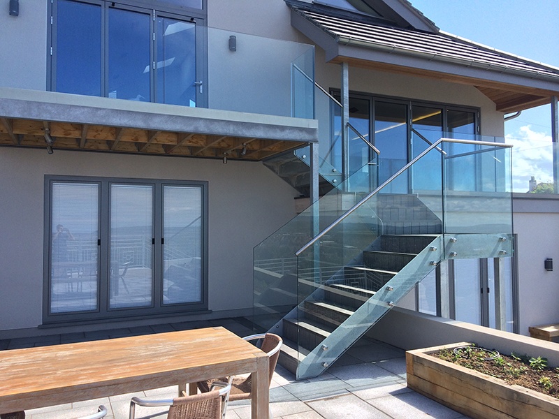 outside beige house with glass balustrading