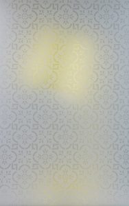 patterned glass in front of yellow lamp