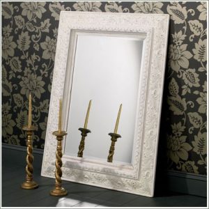 white frame mirror with candles